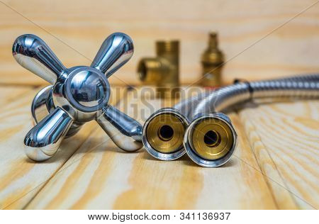 Cruciform Hot And Cold Water Main Switch Of Spare Parts On Wooden Boards