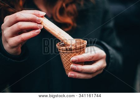 Woman Hands Eating Liquid Chocolate On The Chocolate Market Chocolart In Tübingen, Germany With Chri