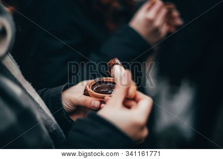 Woman Hands Eating Liquid Chocolate On The Chocolate Market Chocolart In Tübingen, Germany With Chri