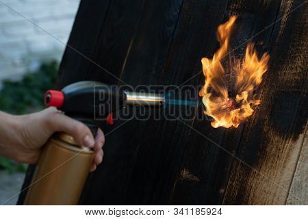 Professional Carpenter Using Old Traditional Japanese Technique. Burning Wood Planks With Gas Burner