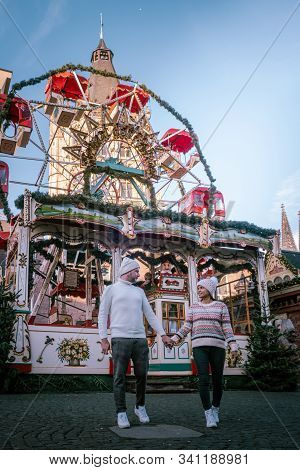 Young Couple Visit The Christmas Market In Cologne Germany During A City Trip, Men And Woman At Chri