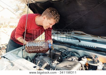 The Concept Of Disability Of People And Their Adaptation To Life. A Disabled Blonde Man Repairs A Ca