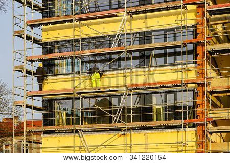 Scaffolding Arround The House To Install Thermal Insulation Of The Apartment Building Facade