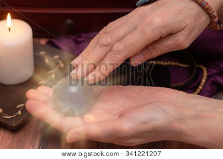 Woman Fortune Teller Holds A Ball Of Fate In Her Hands, A Magic Ball Of Predictions. The Concept Of 