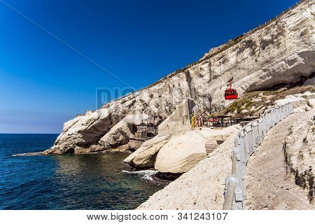 Cableway for descent to sea caves and grottoes. The world's most steep funicular. Grottoes  Rosh a Nikra - geological formation in northern Israel. The concept of active, eco and photo tourism