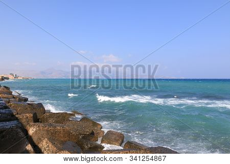 Stone coast by the beautiful blue sea
