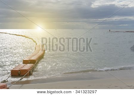 Sunset Or Sunrise With The View Of Calm And No Waves Sea With Modular Floating Pontons And Sand At A