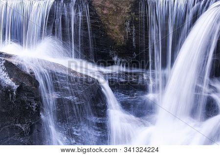 Blurred Waterfalls Flowing Down Through Enders State Forest In Granby Connecticut On A Sunny Winter 