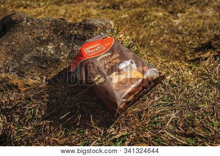 Cambara Do Sul, Brazil - July 18, 2019. Biscuits Packaging Upon Stone And Lawn Polluting The Fortale
