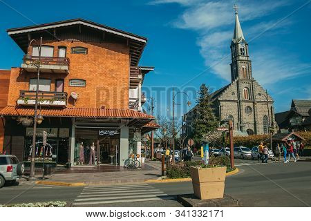 Gramado, Brazil - July 21, 2019. Building With Shop Next To Church And People At Borges De Medeiros 