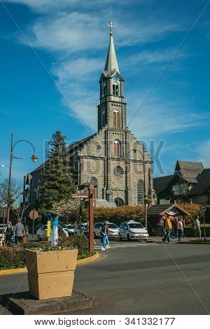 Gramado, Brazil - July 21, 2019. Church Facade With Steeple And People At Borges De Medeiros Avenue,