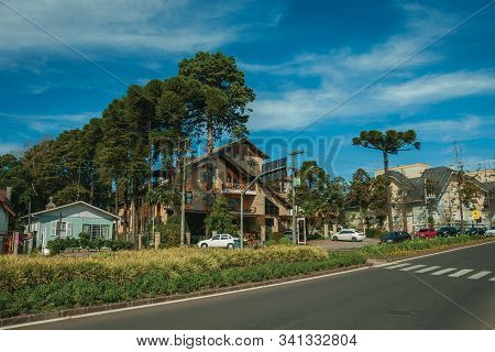 Gramado, Brazil - July 21, 2019. Houses And Trees On An Empty Paved Street In A Sunny Day At Gramado