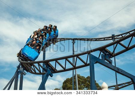 People Having Fun On A Roller Coaster
