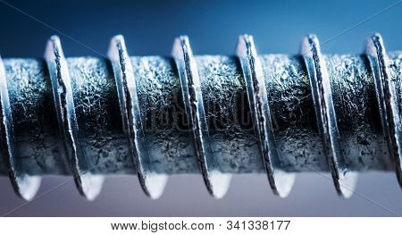 Part of screw with thread on grey background