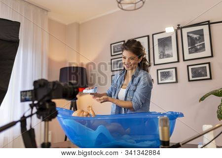 Female Vloger Recording Video About Newborn Baby Bathing As Part Of Online Prenatal Classes; Female 
