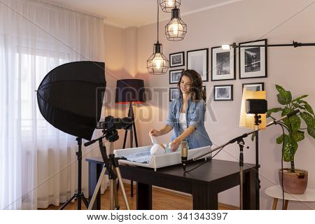 Female Vloger Filming Video About Changing Newborn Baby Clothes As Part Of Online Prenatal Classes C