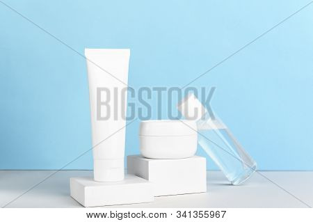 Women Skincare Products Blank Packages Composition On Blue Background. Unbranded Nail Polish Remover