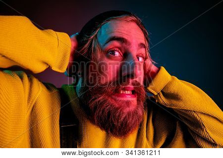 Exremely Shocked, Astonished. Caucasian Mans Portrait On Gradient Studio Background In Neon Light. B