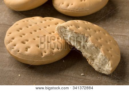 Whole and halved fresh hardtack on the table for a snack