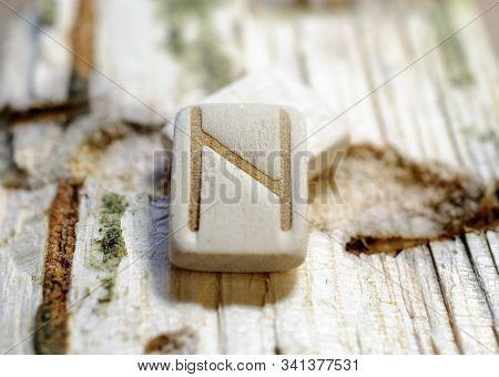 Wooden Rune Hagalz Close-up On A Wooden Background. Soft Focus