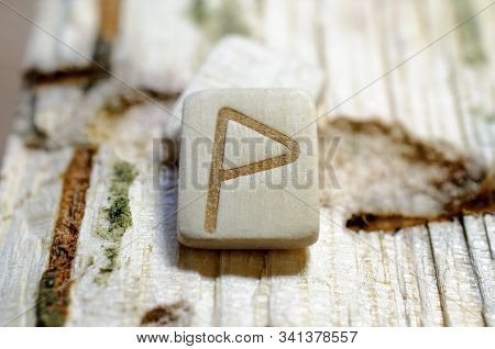 Wooden Rune  Wunjo Close-up On A Wooden Background. Soft Focus