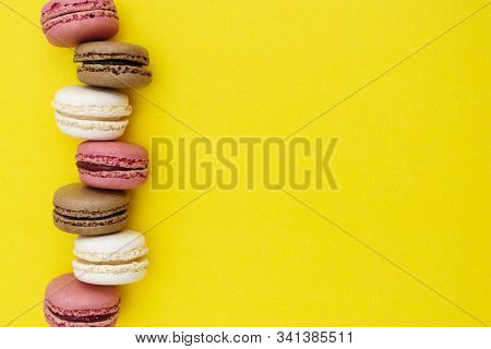 Macarons Cakes. Fashion Or Feminine Background Delicious Macaroons In Row On Yellow Background. Soci