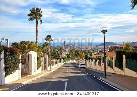 Road With Panoramic View Of Benidorm With Skyscrapers And The Sea On The Horizon On A Sunny Day, Spa