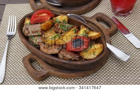 Roasted Meat With Potatoes, Ojaxuri, Hot In Georgian On A Wooden Table. Georgian Cuisine