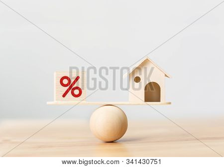 Interest Rate Financial And Mortgage Rates Concept. Wooden Home And Cube Block Shape With Icon Perce