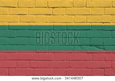 Lithuania Flag Depicted In Paint Colors On Old Brick Wall. Textured Banner On Big Brick Wall Masonry