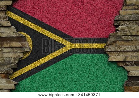 Vanuatu Flag Depicted In Paint Colors On Old Stone Wall Closeup. Textured Banner On Rock Wall Backgr
