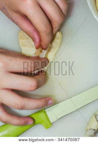The Hands Of A Girl Prepares The Dough For Cookies