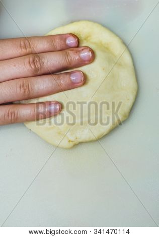 The Hands Of A Girl Prepares The Dough For Cookies