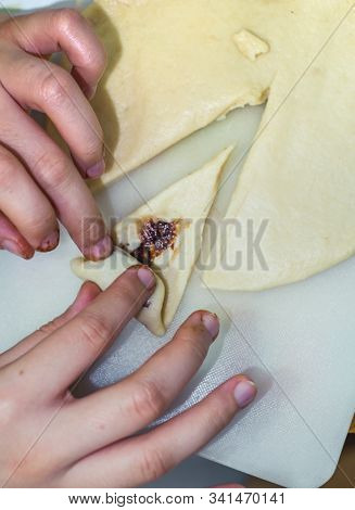 The Hands Of A Girl Prepares The Dough For Cookies