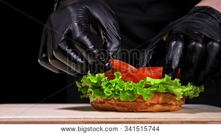 Craft Burger Is Cooking. Consist: Red Sauce Salsa, Lettuce, Red Onion, Pickle, Cheese, Chilli Green 