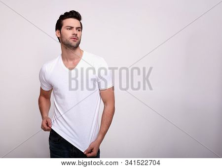 Gorgeous Charming Handsome Sports Man With A Chic Sports Figure, With Dark Volsos And A Beard, In A 