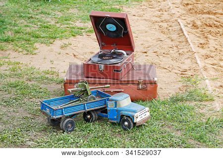 Pushkino, Moscow Region, Russia - July 13, 2019: Vintage Gramophone, Suitcase And Toy Truck With Ant