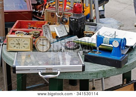 Pushkino, Moscow Region, Russia - July 13, 2019: Still Life Of Old Clock, Sewing Machine, Book, Sign