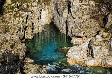 Limpid Mountain Stream Flows Cold Among Millennial Rocks Of The Vicenza Alps Carved Out By Time In C