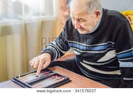Senior Man Playing Backgammon In A Nursing Home