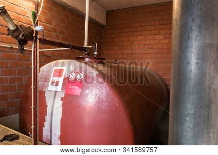 In A Separate Room In A Old Building, There Is A Heating Oil Tank