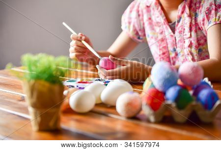 Young Girl Painting Easter Eggs For Eastertime At Home