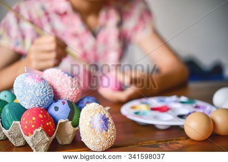 Young Girl Painting Easter Eggs For Eastertime At Home