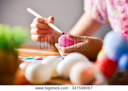 Young Girl Painting Easter Eggs For Eastertime At Home