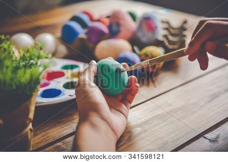 Young Girl Painting Easter Eggs For Eastertime At Home