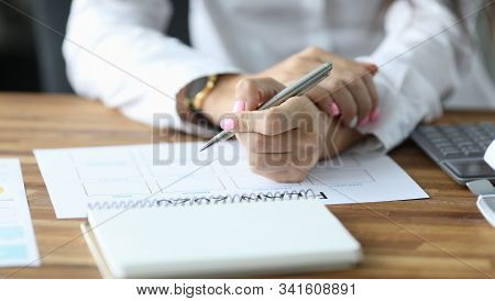 Close-up View Of Womans Hands Filling Paper With Months. Person Sitting In Office With Silver Pen An