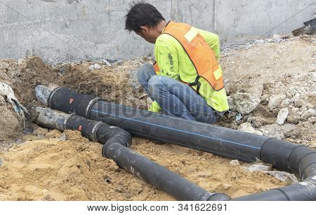 Two Workers Are Helping To Cut The Steel Wire By Gas In The Concrete Pile.