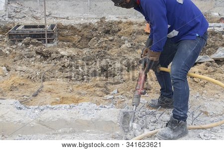 Two Workers Are Helping To Cut The Steel Wire By Gas In The Concrete Pile.