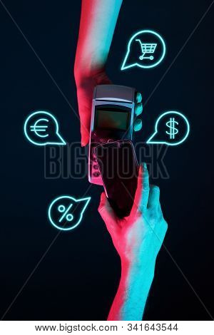 Concept Of Online Or Wireless Payments. Hands With Pinpad And Phone With Payment Icons. Modern Neon 