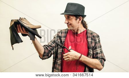 Cobbler Holding Set Of Tools And Leather. Small Business Concept. Handmade Leather Shoes. Shoemaker